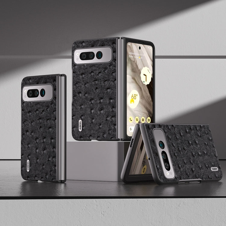 Black ostrich-textured leather fold phone case on display with hinge and camera cutout