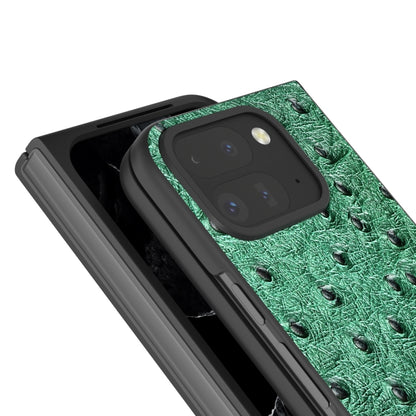 Green ostrich-textured leather fold phone case close-up with camera cutout