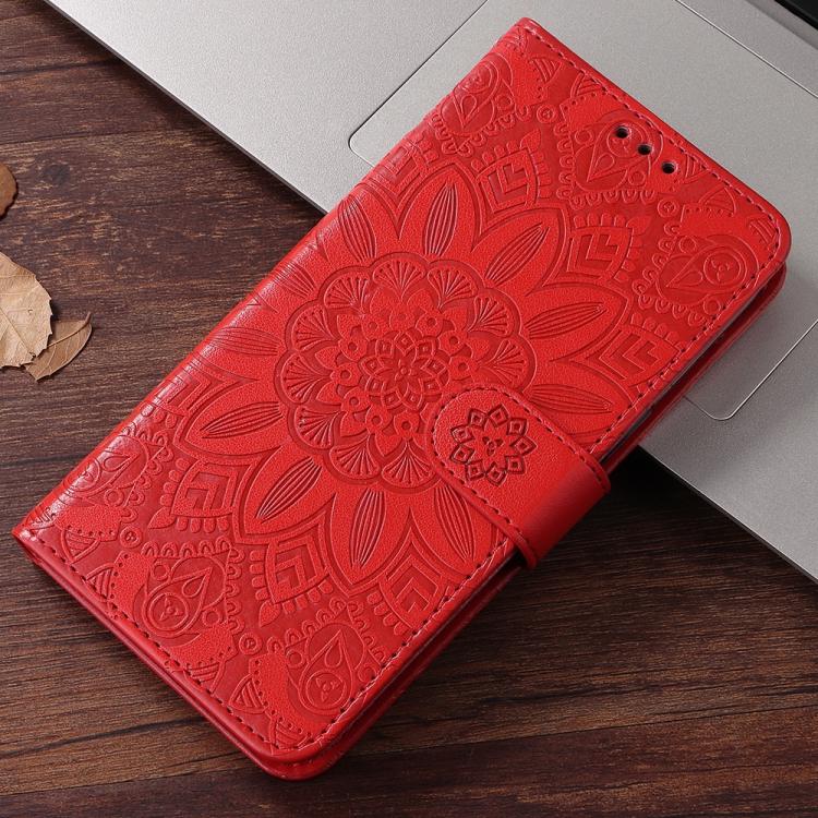 Red embossed sunflower leather wallet phone case with magnetic closure on wooden desk