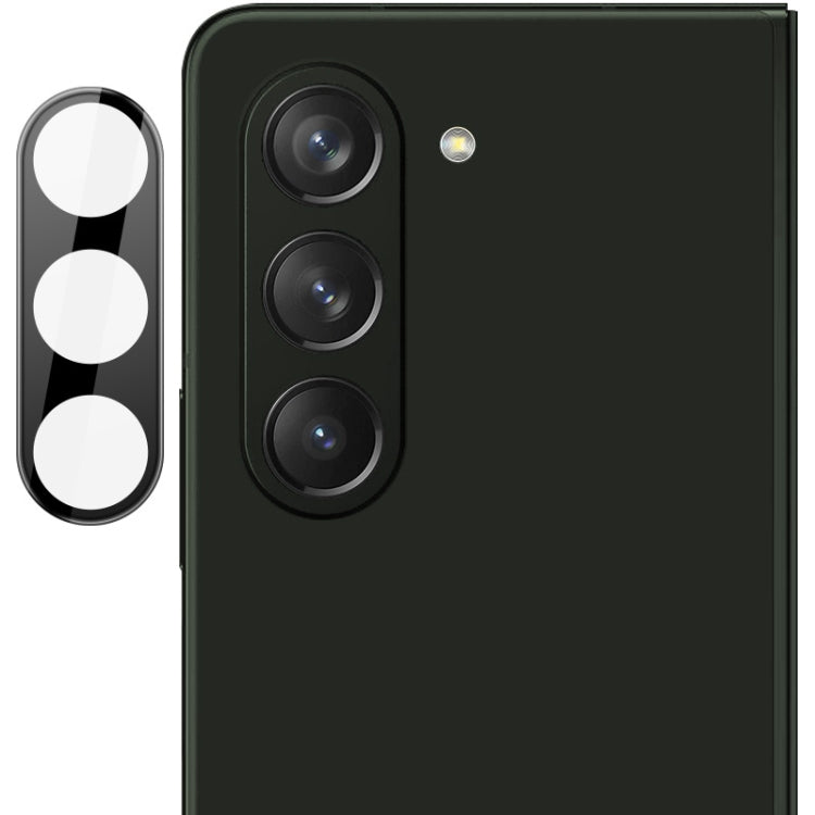 Black integrated glass lens film with cutouts for three rear camera lenses