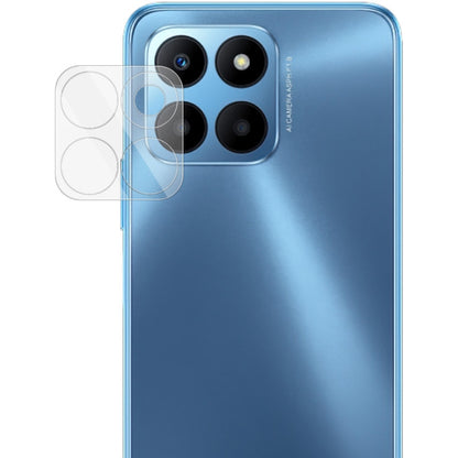 Integrated glass lens film for phone camera, with clear covers over lens openings.