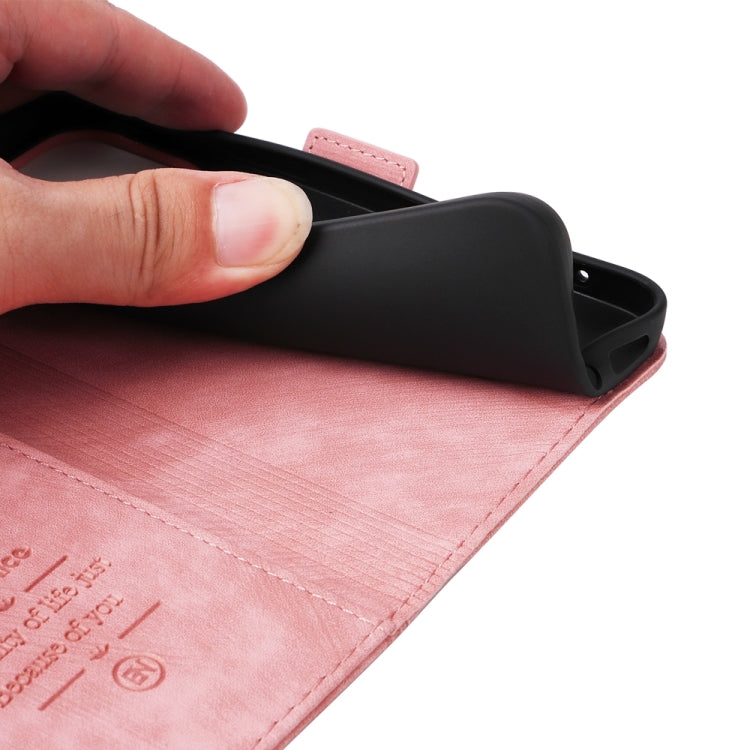 Pink leather phone case with fold-over cover and black inner shell