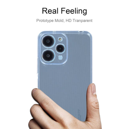 Clear slim TPU phone case with camera openings, held in hand for Xiaomi Redmi 12