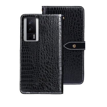 Black crocodile-texture leather flip phone case with wrist strap and magnetic tab.