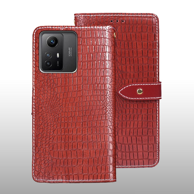 Red crocodile-texture leather flip phone case with wrist strap and magnetic tab.
