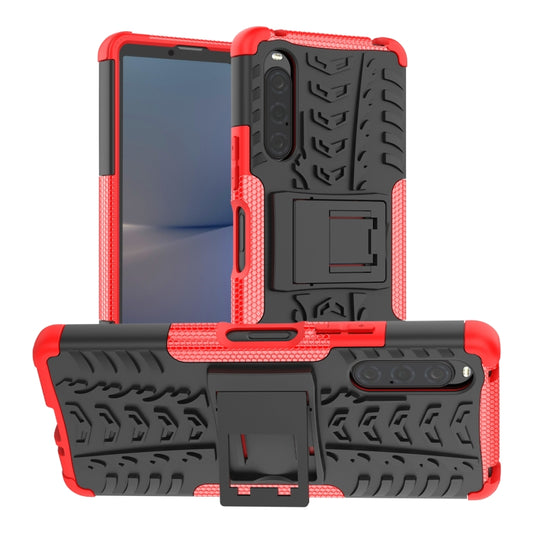 Red rugged phone case with tire-tread texture and built-in holder/stand