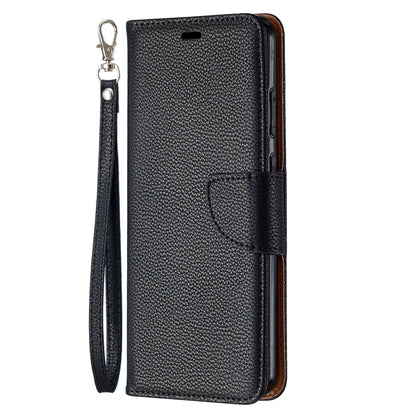 Textured leather flip phone case with wrist lanyard and magnetic-style closure flap.