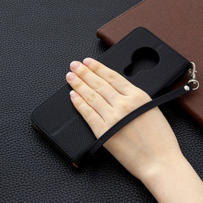 Textured leather flip phone wallet case with strap and card holder, shown with hand.