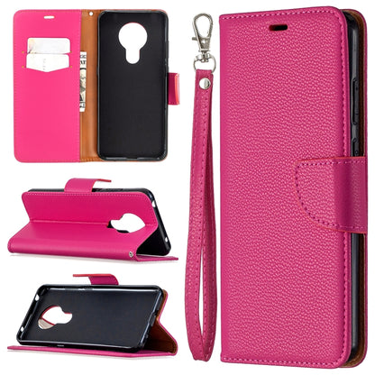 Pink textured leather flip phone case with card slots and wrist lanyard strap