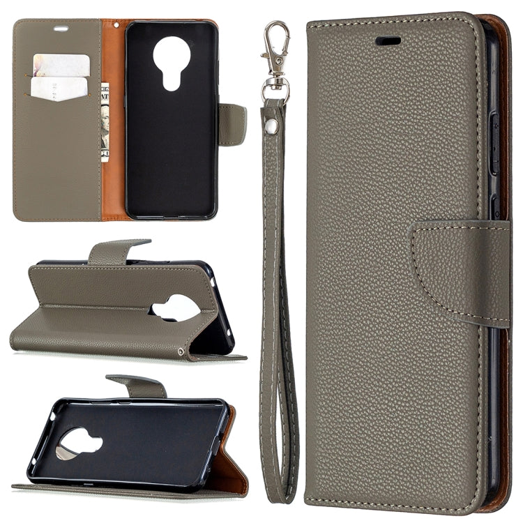 Gray textured leather flip phone case with card slots and wrist lanyard strap