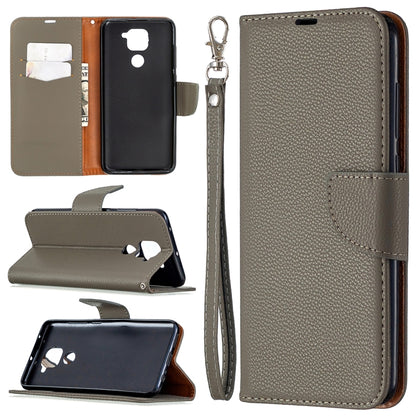 Gray leather phone case with card slots, stand, and wrist lanyard strap