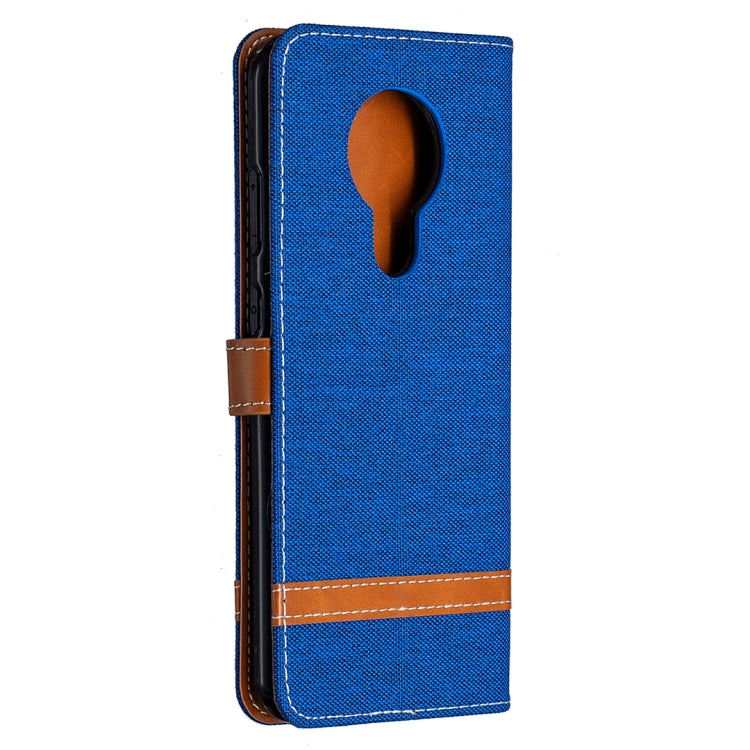 Blue denim flip phone case with oval camera cutout and brown leather trim