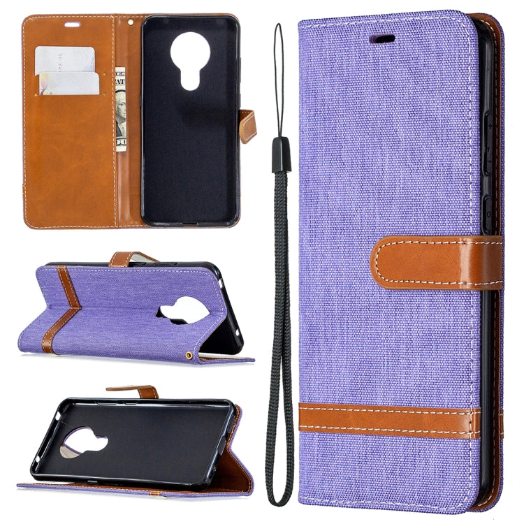 Denim-textured flip phone case with card slots and lanyard, purple with tan accents