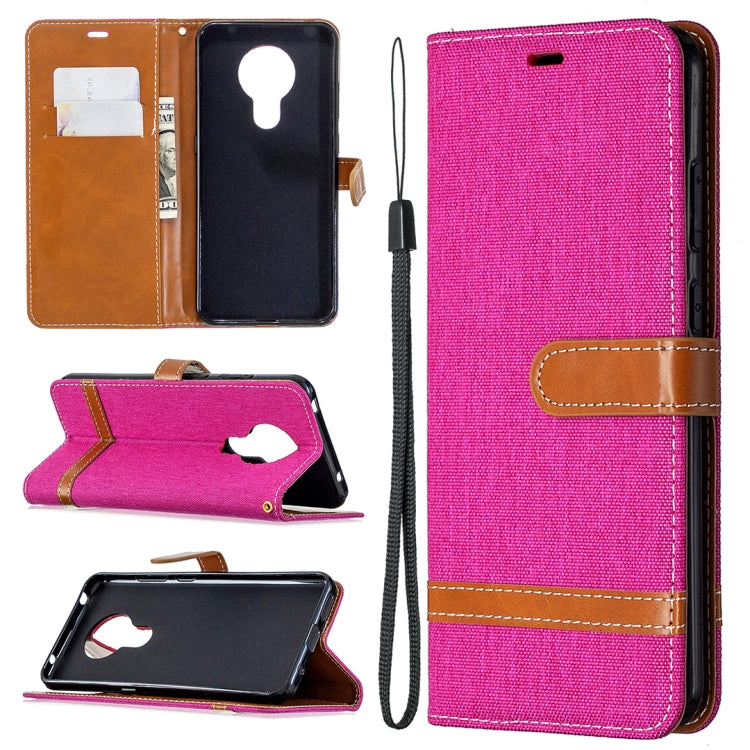 Denim-textured flip phone case with card slots and lanyard, hot pink with tan accents