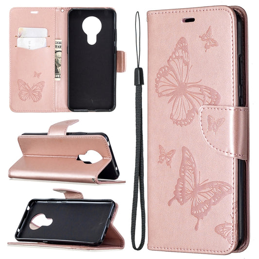 Pink leather flip phone wallet case with embossed butterflies, card holder, and lanyard