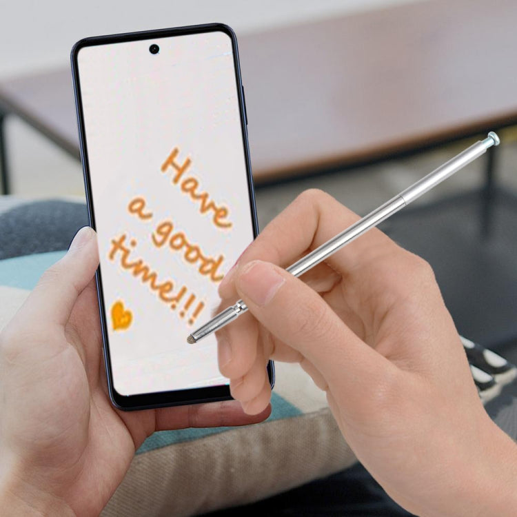 Silver stylus pen held in hand, writing on smartphone screen