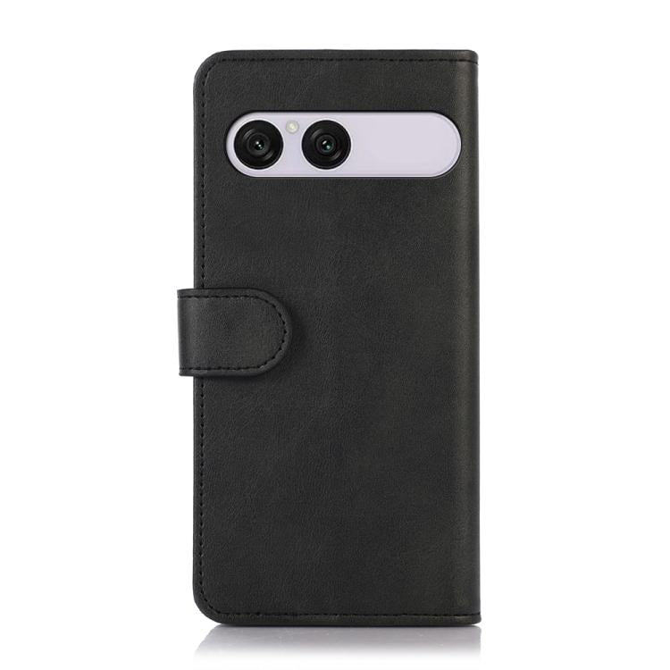 Black cow-texture leather phone case with folio flap and dual-camera cutout.
