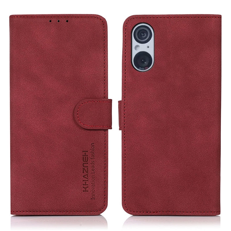 Red matte leather flip phone case with side strap and camera cutout