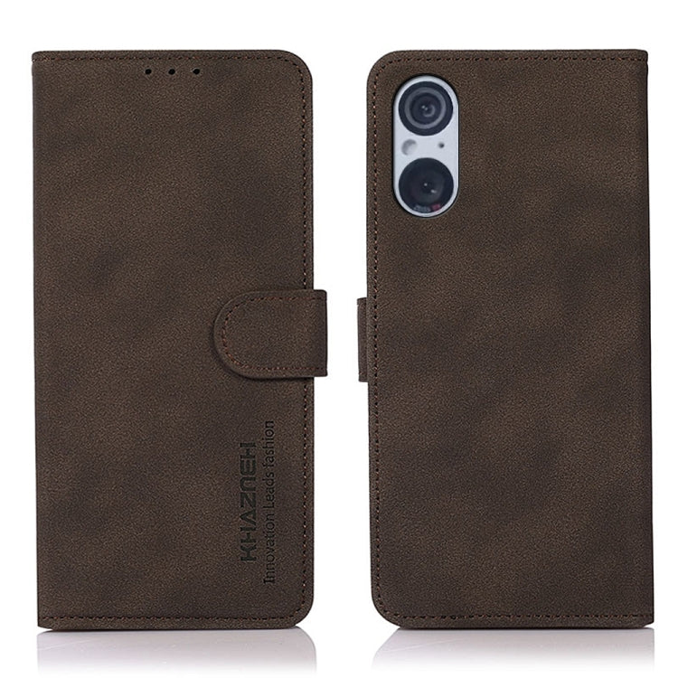Brown matte leather flip phone case with side strap and camera cutout