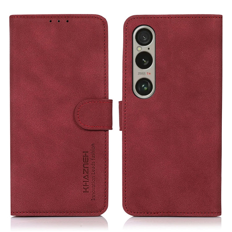 Red matte leather flip phone case with side strap and triple-camera cutout