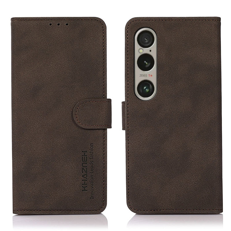 Brown matte leather flip phone case with side strap and triple-camera cutout