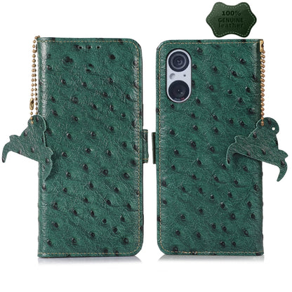 Green ostrich leather phone wallet case with animal charm and beaded side strap