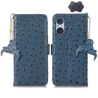 Blue ostrich leather phone wallet case with dual camera cutout, animal charm and strap