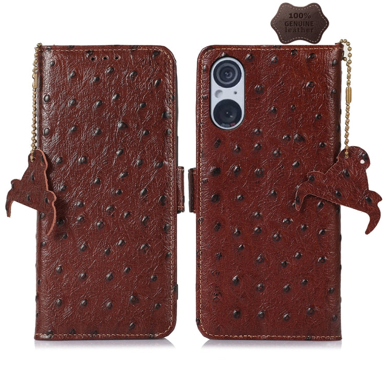 Coffee brown ostrich leather phone wallet case with dual camera cutout, animal charm and strap