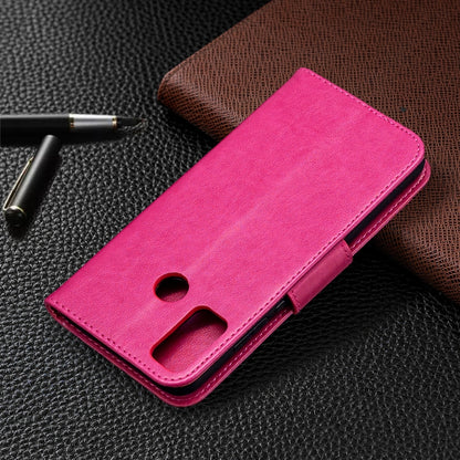 Pink leather flip phone case with embossed butterflies and phone stand cutout