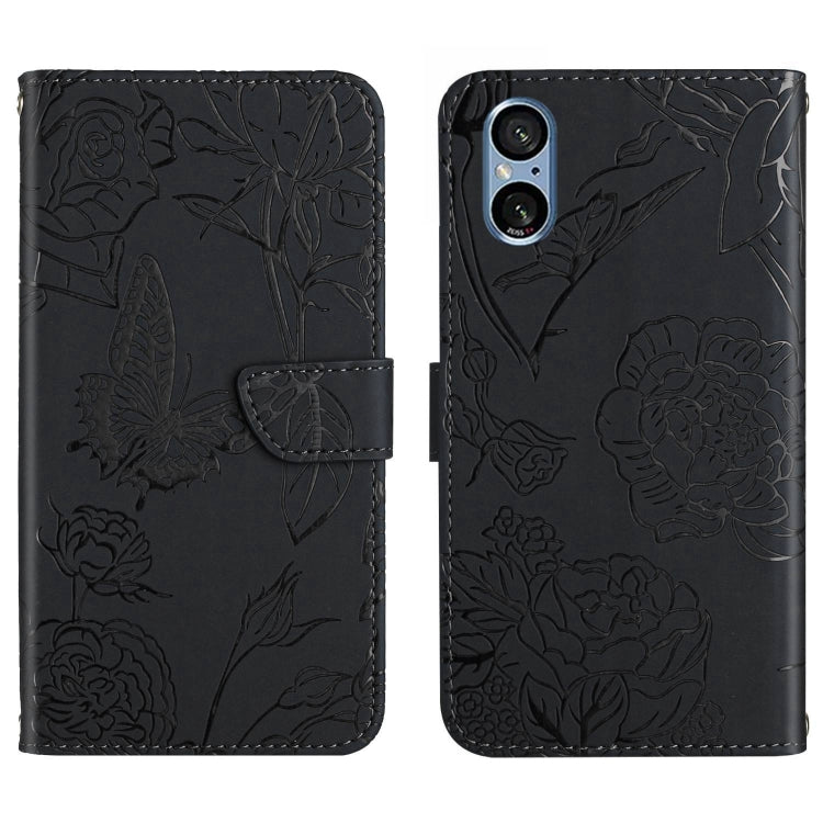 Black butterfly embossed leather phone case with folding flap and camera cutouts