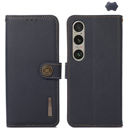 Blue genuine leather phone case with flip cover, camera cutout, and branded leather tab