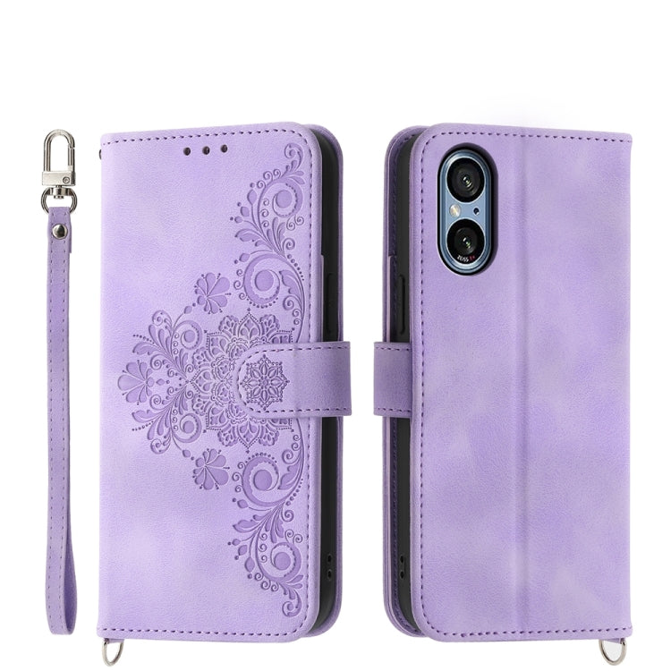 Lavender embossed floral wallet phone case with wrist strap and magnetic closure