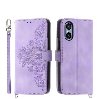 Lavender embossed floral wallet phone case with wrist strap and magnetic closure