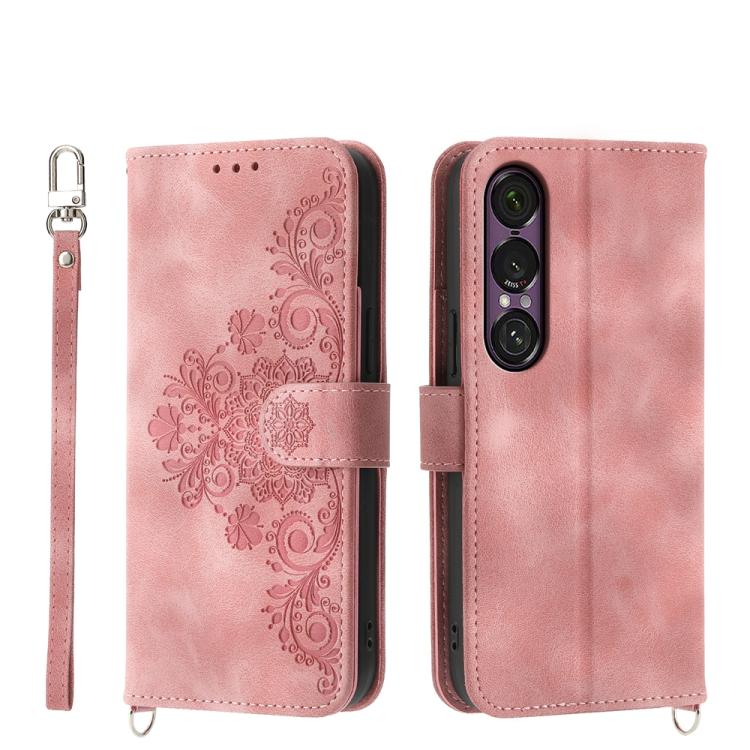 Pink embossed floral wallet phone case with wrist strap and magnetic closure