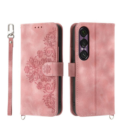 Pink embossed floral wallet phone case with wrist strap and magnetic closure