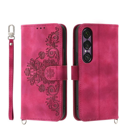 Magenta embossed floral wallet phone case with wrist strap and magnetic closure