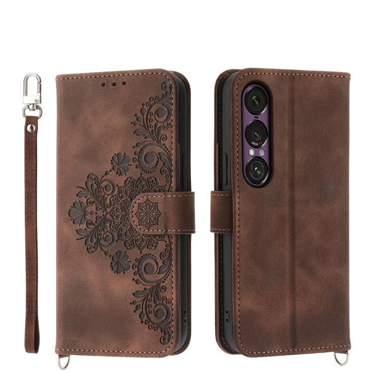 Brown embossed floral wallet phone case with wrist strap and magnetic closure