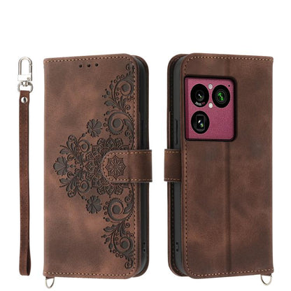 Brown embossed floral wallet phone case with wrist strap and magnetic closure