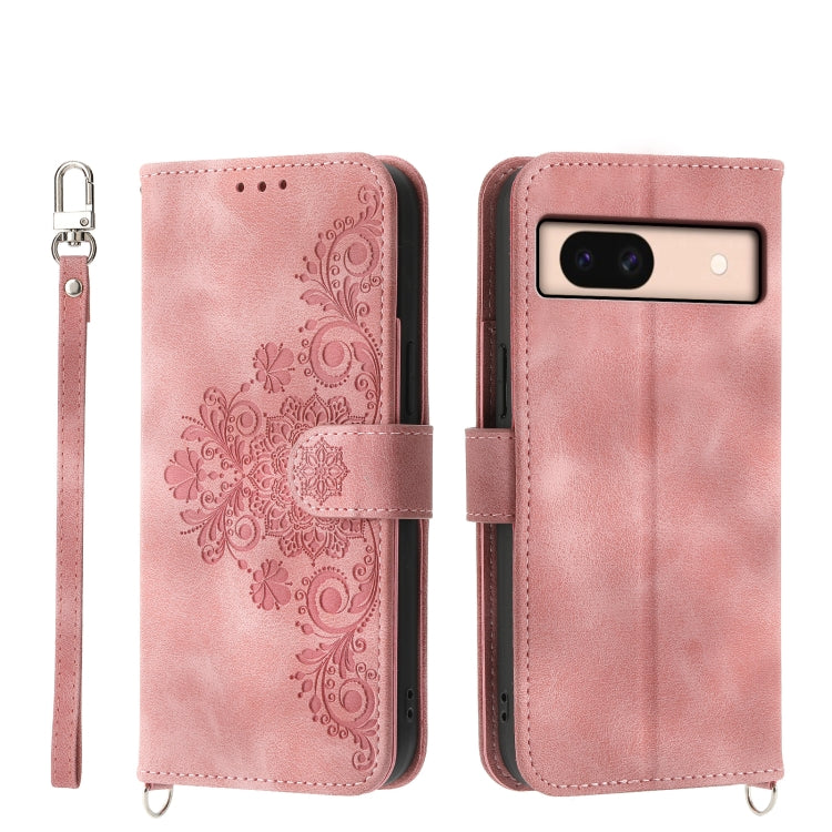 Embossed leather wallet phone case in blush pink with floral pattern and wrist strap