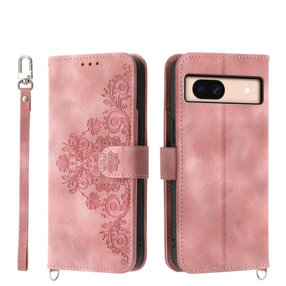 Embossed leather wallet phone case in blush pink with floral pattern and wrist strap
