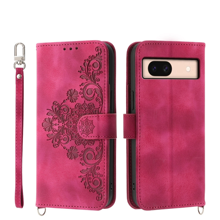 Embossed leather wallet phone case in bright pink with floral pattern and wrist strap