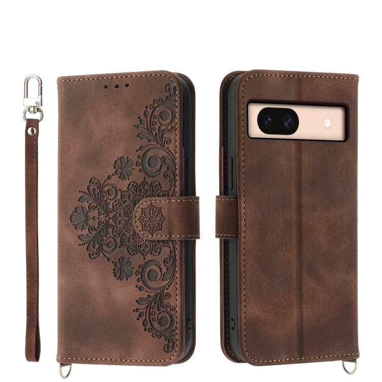 Embossed leather wallet phone case in brown with floral pattern and wrist strap