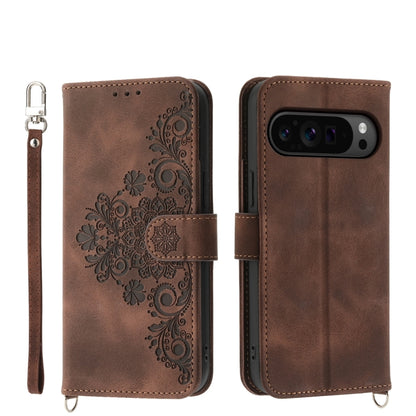 Brown embossed floral leather wallet phone case with wrist strap and flip cover