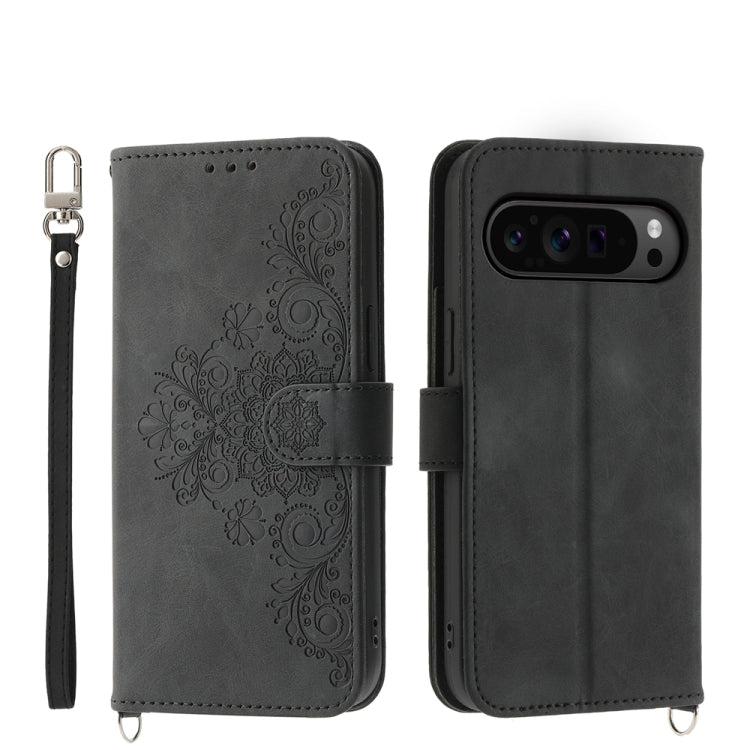 Black embossed floral leather wallet phone case with wrist strap and flip cover