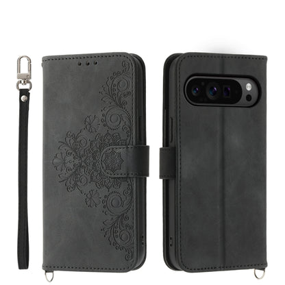 Black embossed floral leather wallet phone case with wrist strap and flip cover