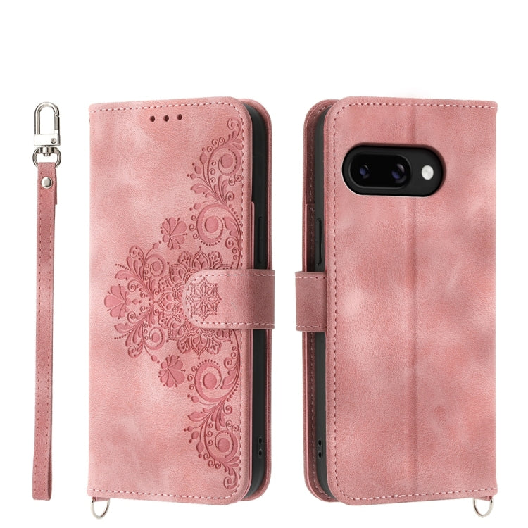 Light pink leather phone wallet case with embossed floral pattern and wrist strap