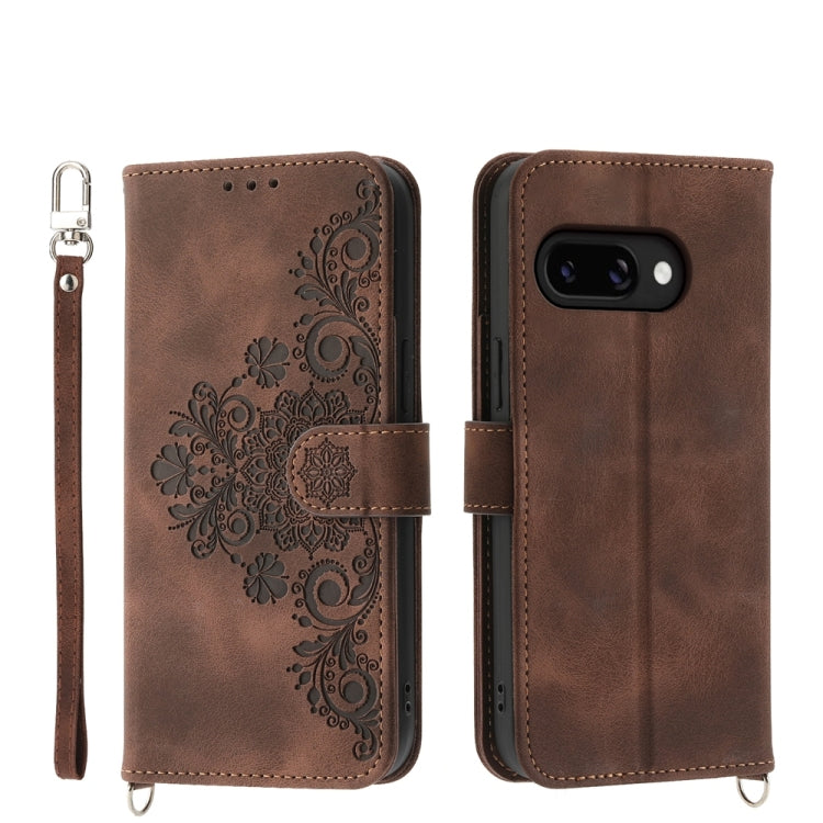 Brown leather phone wallet case with embossed floral pattern and wrist strap