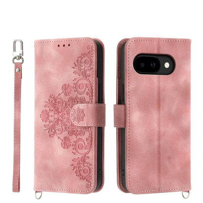 Light pink leather phone wallet case with embossed floral pattern and wrist strap