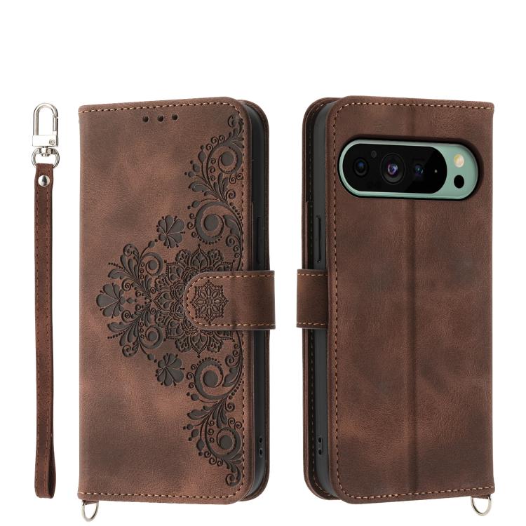 Brown leather phone wallet case with embossed floral pattern, wrist strap, camera cutout