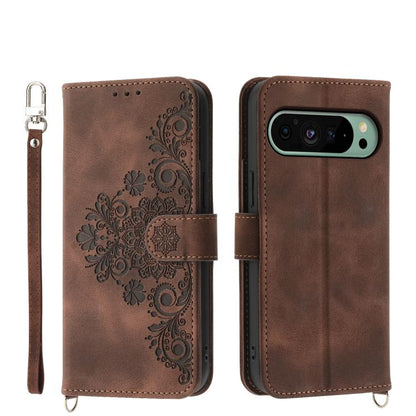 Brown leather phone wallet case with embossed floral pattern, wrist strap, camera cutout